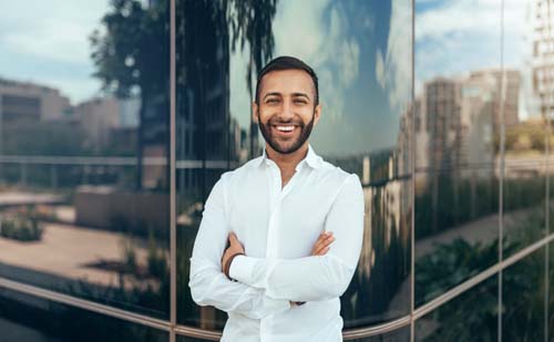 Portrait of a young confident smiling indian man who believes in himself